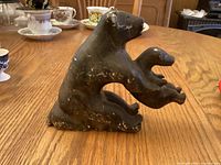 Left side view of soapstone mother bear holding cub