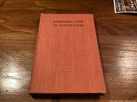 Front cover of orange cloth book titled Something New In Sandwiches