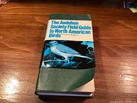 Front view of green vinyl-bound Audubon field guide with dust-jacket band