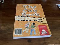 Front cover of "The Cub Book" showing title, subtitle, illustration and Scouts Canada logo