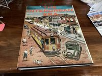 Front of hardcover book showing title, author and illustrated dust jacket