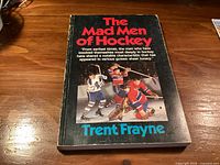 Front cover of the book showing title, author and hockey imagery