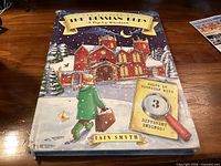 Front cover showing title, author and snowy mansion artwork