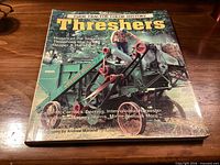 Front cover of Threshers book shows title, subtitle and machinery photo