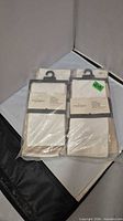 Four Threshold pillow cover packages in clear plastic bag