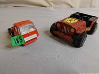 Front view of both Tonka vehicles showing colors, decals, overall wear