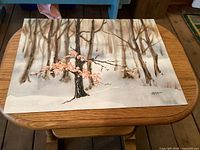 Full view of unframed watercolor painting on wooden table