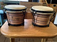 Top and side view of both bongo drums showing hide heads and shell finish