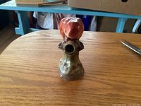Front view of ceramic parrot bud vase