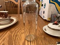 Full view of glass candle holder on table