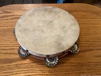 Top view of tambourine showing hide head and jingles