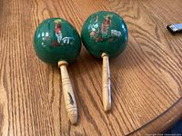 Two green maracas on table