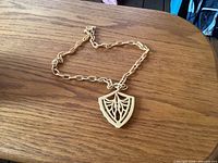 Full necklace laid on table, showing chain and pendant