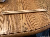 Pair of wooden drum sticks on table
