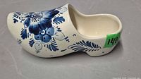 Left side profile of blue and white ceramic clog