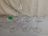 Group view of three matching round-bowl glasses and one taller wine glass