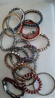 Cluster of assorted stretch and bangle bracelets showing variety of colours and styles