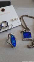 All jewellery pieces: necklace, ring, three earring pairs on American Eagle card