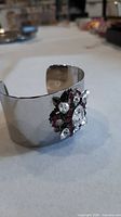 Angle view of cuff showing exterior finish and crystal motif