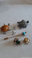 Group shot of all turtle jewellery and butterfly stick pin
