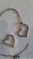 Chain with both heart pendants displayed on neutral background
