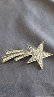 Front view of rhinestone shooting star brooch