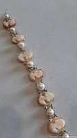 Full view of bracelet showing alternating cameos and pearls
