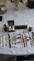 Overview of all twenty watches and one strap laid out on table