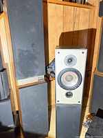 Mission Argonaut speaker beside Paradigm speaker, showing size and cabinet style