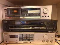 Front view of stacked TEAC V-23 cassette deck, TEAC Quartz component and Sony receiver