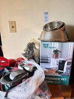 Boxed Wopet feeder, stacked metal bowls, bag of leashes