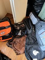 Group view of all bags and guitar cases on floor