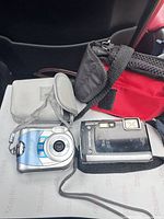 Overview showing two digital cameras and two camera cases