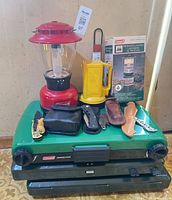 Overview of all camping items stacked on stoves