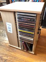 Full view of wooden CD cabinet loaded with discs