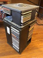 Full view of stacked black CD storage towers filled with discs