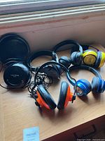 Overall view showing Centrios transmitter and five pairs of headphones on table
