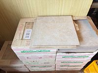 Stack of Durker tile boxes with loose tile showing surface pattern