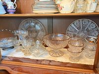 Overall view of glass serveware in cabinet