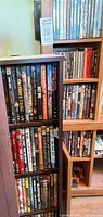 Front view of tall shelf packed with DVD cases and adjoining shelf sections