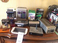 Overall shot showing all electronic devices, film packs and cards on dresser