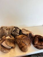 Six fur hats arranged on table