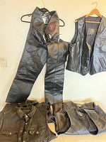 Group shot of all vests and pants hung and laid out