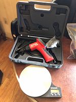 Scale and inspection camera in open case on table