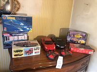 Overall lot showing all model kits and RC cars on tabletop