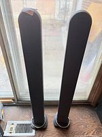 Front view of both tall speakers showing height and design