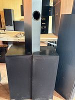 Front view of both black speaker cabinets side-by-side