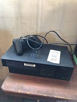 Sony PlayStation 2 console with controller resting on top