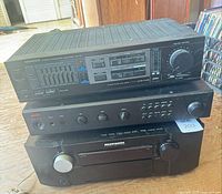Front view of Kenwood KA-75 amplifier stacked over Adcom preamp and Marantz receiver
