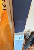 Front view showing stacked Acoustic Research bookshelf speakers and tall floor-standing speaker